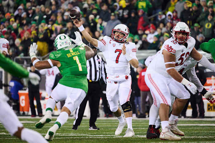 Utah Utes quarterback Cameron Rising (7) throws a pass during the first half against Oregon Ducks linebacker Noah Sewell (1) at Autzen Stadium.